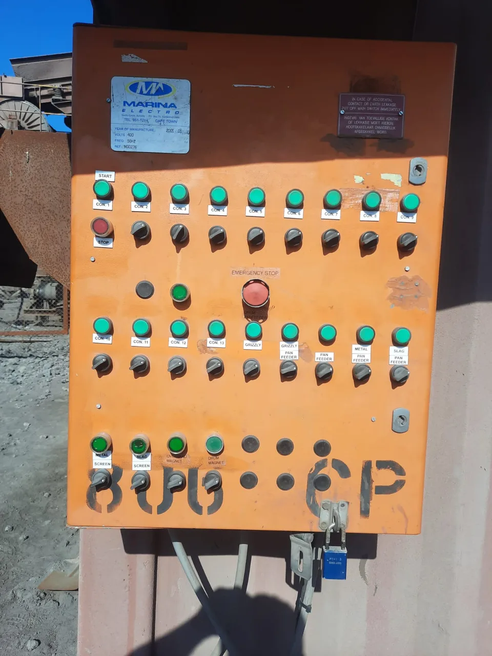 Labelled switches and indicator lights on an industrial control panel.