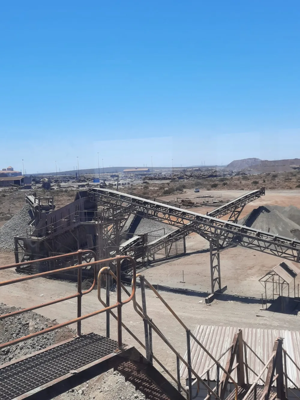 Elevated view across conveyors and steel structures at the Saldanha metal recovery plant.